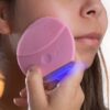 limpando o rosto com massageador facial